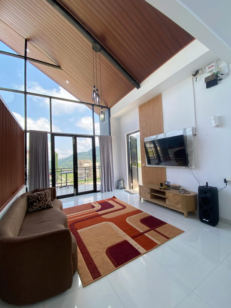 Bright and stylish living room with large windows and elegant decor.